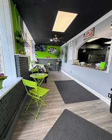 Interior of Rock Solid Grill with green cafe seating and order window