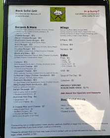 Printed Rock Solid Grill menu board with burgers, wings and sides